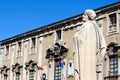 Catania, Italy - Apr 10th 2019: Beautiful detail of Antique statue on Baroque Catania Cathedral with blurred Town Hall building