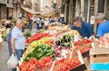 Costumers and sellers in the historical street market in Catania, Italy.