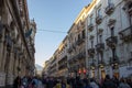 Catania via etnea long view with people walking, shops and historical buildings