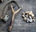 Catapult with stones on wood background