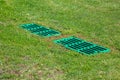 Catch basin grate drainage on the lawn with green grass septic tank. Royalty Free Stock Photo