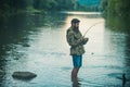 Catch fish. Holding brown trout. Portrait of cheerful man fishing. Angler. Royalty Free Stock Photo