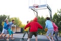 Catch it. positive delighted teenager boys play basketball, want to win