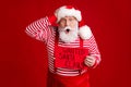 Catch thief. Photo of retired old man grey beard shock hand head open mouth crime scene wear santa costume suspenders