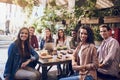 We always catch-up, even just for a quick lunch. a group of friends out for lunch at a cafe.