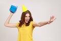 Catch your present. Take it. Happy carefree young female in yellow t-shirt ready to throw birthday