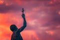 Catcher of a Cross statue at dusk