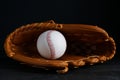 Catcher`s mitt and baseball ball on black background. Sports game Royalty Free Stock Photo