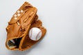 Catcher\'s mitt and baseball ball on white background, top view with space for text. Sports game Royalty Free Stock Photo