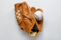 Catcher`s mitt and baseball ball on white background, top view. Sports game Royalty Free Stock Photo