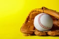 Catcher`s mitt and baseball ball on yellow background, space for text. Sports game Royalty Free Stock Photo