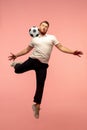 Full length portrait of young successfull high jumping man gesturing isolated on pink studio background Royalty Free Stock Photo