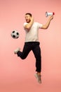 Full length portrait of young successfull high jumping man gesturing isolated on pink studio background Royalty Free Stock Photo