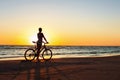 Catching a moment in time. Sporty woman cyclist at sunset background. Royalty Free Stock Photo