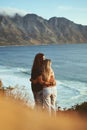 Catching sunsets with my love. an affectionate young couple standing together and looking out at sea during a day Royalty Free Stock Photo