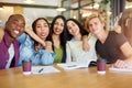 Catching up in the cafeteria. Portrait of a group of happy students having a study session in a cafe. Royalty Free Stock Photo