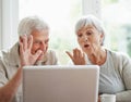 Catching up with the grandkids. A cheerful senior couple having a video chat on a laptop. Royalty Free Stock Photo