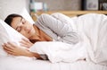 Catching up on her beauty sleep. an attractive young woman asleep in her bed. Royalty Free Stock Photo