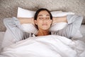 Catching up on her beauty sleep. an attractive young woman asleep in her bed. Royalty Free Stock Photo