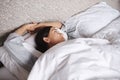 Catching up on her beauty sleep. an attractive young woman asleep in her bed. Royalty Free Stock Photo