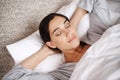 Catching up on her beauty sleep. an attractive young woman asleep in her bed. Royalty Free Stock Photo