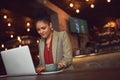 Catching up on her emails. a young businesswoman working on her laptop in a cafe.