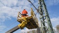 Catenary line fitters working on a tensioning device