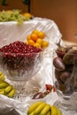 Catered Wedding Fruit Table with Pomegranate Seeds, Oranges, Prickley Pears, Bananas, Grapes and Strawberries Royalty Free Stock Photo