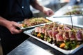 caterer organizing seared tuna steak dishes for an event