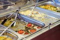 Catering bain-marie with empty leftover foods displayed in a cafeteria