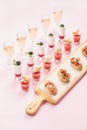 Catering, banquet, party food concept over pastel pink background