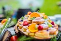 Catering buffet food outdoor. Cakes colorful fresh fruits berries oranges grapes and herb decorations Royalty Free Stock Photo