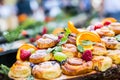 Catering buffet food outdoor. Cakes colorful fresh fruits berries oranges grapes and herb decorations Royalty Free Stock Photo