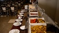 Catering buffet with heated trays ready to serve. Line with trays of food on a buffet table. Meals for breakfast and Royalty Free Stock Photo