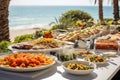 Catering buffet meal on a white long table in a modern restaurant by the sea