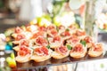 Catering buffet table with snacks and appetizers. Set of canapÃÂ©s with jamon, bruschetta and cheese