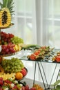 Catering buffet table with snacks and appetizers. Set of varios fruits and berries. Decorative vase Royalty Free Stock Photo