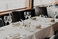 Catering and celebration concept. Festive served dinner table with glasses and cutlery on white tablewear in luxury banquet with n Royalty Free Stock Photo