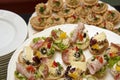 Catering, company food service, plates full of fresh tasty food and small appetizers, banquet concept, lots of small sandwiches