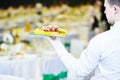 Catering event service. Waiter hand with food Royalty Free Stock Photo