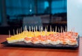 Catering food Ã¢â¬â canapes with salmon and cheese served on black stone tray