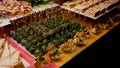 Catering. Lots of green canapes, meat rolls, sandwiches. On the yellow table.