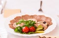 Catering platter of sliced cured meat and ham with vegetable decoration on easter table Royalty Free Stock Photo