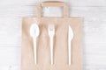 Catering and street fast food plastic fork, spoon, knife on paper bag.Eco-friendly food packaging and cotton eco bags on Royalty Free Stock Photo