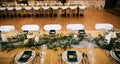 Catering, table set.  Beautiful table decoration in a restaurant with green leaves and candles Royalty Free Stock Photo