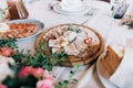 Catering table set service with food and drink at restaurant before wedding party Royalty Free Stock Photo