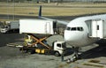 Catering truck and scissor lift supplying a passenger jet