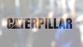 Caterpillar Inc. logo on a glass against blurred crowd on the steet. Editorial 3D rendering