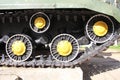 Caterpillar and rollers of the Russian tank SU-152, view from the side. Fragment of the chassis of the military armored vehicle of