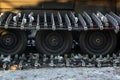 Caterpillar spikes on snowmobile in ski resort. Machine wheels with spikes for winter off road, extreme conditions. Tracked quad